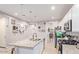 Kitchen with an island, white cabinets and pantry at 17536 W Desert Bloom St, Goodyear, AZ 85338