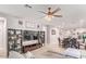 Living room features a large TV and built-in shelving at 17536 W Desert Bloom St, Goodyear, AZ 85338