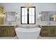 Luxurious bathroom featuring dual vanities, a freestanding tub, a chandelier, and tile flooring at 19912 E Karsten Dr, Queen Creek, AZ 85142