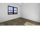 Sunlit bedroom featuring hardwood floors, white walls, and a large window offering natural light at 19912 E Karsten Dr, Queen Creek, AZ 85142