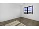 Well-lit bedroom featuring hardwood floors, a large window, and white walls at 19912 E Karsten Dr, Queen Creek, AZ 85142