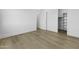 Minimal bedroom featuring hardwood flooring, open closet, and neutral tones at 19912 E Karsten Dr, Queen Creek, AZ 85142