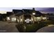 Stunning home exterior illuminated at dusk, showcasing the manicured front yard and inviting facade at 19912 E Karsten Dr, Queen Creek, AZ 85142