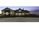 Gorgeous home boasts a stone facade, manicured lawn, and professional landscaping at 19912 E Karsten Dr, Queen Creek, AZ 85142