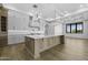 Spacious kitchen features a large island, white cabinets, and designer lighting at 19912 E Karsten Dr, Queen Creek, AZ 85142