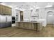 Spacious kitchen showcasing a large island, stainless steel appliances, and custom wood cabinetry at 19912 E Karsten Dr, Queen Creek, AZ 85142