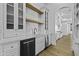 Kitchenette area showcasing white cabinetry, wood floating shelves, and a stainless steel under-counter refrigerator at 19912 E Karsten Dr, Queen Creek, AZ 85142