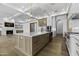 Open-concept kitchen with an island, custom cabinets, stainless appliances, and wood flooring at 19912 E Karsten Dr, Queen Creek, AZ 85142