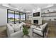 Bright living room featuring a stone fireplace, hardwood floors, and large glass doors to the outdoor living space at 19912 E Karsten Dr, Queen Creek, AZ 85142