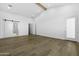 Bright living room featuring hardwood floors, white walls, sliding doors and an entry to an additional room at 19912 E Karsten Dr, Queen Creek, AZ 85142