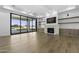 Bright living room features a stone fireplace, light wood floors, and sliding glass doors to outdoor area at 19912 E Karsten Dr, Queen Creek, AZ 85142