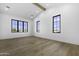 Bright living room featuring hardwood floors, white walls, vaulted ceilings and large windows with black trim at 19912 E Karsten Dr, Queen Creek, AZ 85142