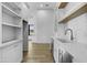 Walk-in pantry features white cabinetry, marble countertop, open shelving, and beverage cooler at 19912 E Karsten Dr, Queen Creek, AZ 85142