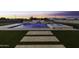 Backyard with a luxurious pool and spa area, featuring a cascading waterfall design and artificial grass at 19912 E Karsten Dr, Queen Creek, AZ 85142
