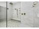 Modern shower with glass enclosure, a bench, rainfall shower head and elegant tile work at 19912 E Karsten Dr, Queen Creek, AZ 85142