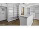 Spacious walk-in closet with custom shelving and drawers, and hardwood floors at 19912 E Karsten Dr, Queen Creek, AZ 85142