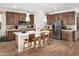 Modern kitchen with island, stainless steel appliances, and wood cabinets at 20622 N 226Th Ln, Surprise, AZ 85387