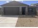 Charming single story home with a two car garage and low maintenance desert landscaping at 20622 N 226Th Ln, Surprise, AZ 85387