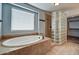Bathroom features a large soaking tub and glass block shower at 23116 N 41St St, Phoenix, AZ 85050