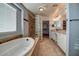 Main bathroom with double vanity, soaking tub, and walk-in shower at 23116 N 41St St, Phoenix, AZ 85050