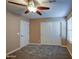 Charming bedroom with ceiling fan and double door closet at 23116 N 41St St, Phoenix, AZ 85050