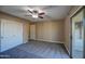 Spacious bedroom with ceiling fan, carpet, and sliding glass door to balcony at 23116 N 41St St, Phoenix, AZ 85050