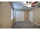 Cozy bedroom with ceiling fan and double door closet at 23116 N 41St St, Phoenix, AZ 85050