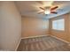 Well-lit bedroom with ceiling fan and carpet flooring at 23116 N 41St St, Phoenix, AZ 85050