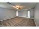 Spacious bedroom with carpet, ceiling fan and neutral walls at 23116 N 41St St, Phoenix, AZ 85050