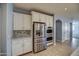 Modern kitchen with stainless steel appliances and white cabinetry at 23116 N 41St St, Phoenix, AZ 85050