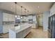Modern kitchen with white cabinets and large island at 23116 N 41St St, Phoenix, AZ 85050