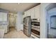Modern kitchen with stainless steel appliances and white cabinetry at 23116 N 41St St, Phoenix, AZ 85050
