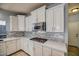 Bright kitchen with white cabinets, gas cooktop and stainless steel appliances at 23116 N 41St St, Phoenix, AZ 85050
