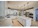 Spacious kitchen with white cabinets, stainless steel appliances, and an island at 23116 N 41St St, Phoenix, AZ 85050