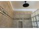 Close-up view of shower with unique tile work and glass block feature at 23116 N 41St St, Phoenix, AZ 85050