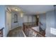 Upper hallway with carpet, doors to bedrooms, and a decorative railing at 23116 N 41St St, Phoenix, AZ 85050