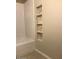 Clean bathroom with a tub and a built-in shelving niche for storage or decor at 2400 N 71St St # T, Scottsdale, AZ 85257