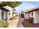 Paved pathway winds through a well-manicured community with desert landscaping at 2400 N 71St St # T, Scottsdale, AZ 85257
