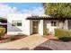 White stucco exterior, private entrance, and well-maintained landscaping at 2400 N 71St St # T, Scottsdale, AZ 85257
