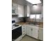 Bright kitchen with white cabinets, stainless steel sink, and modern appliances at 2400 N 71St St # T, Scottsdale, AZ 85257