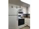 White kitchen appliances including refrigerator, microwave, and range at 2400 N 71St St # T, Scottsdale, AZ 85257