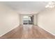 Living room with wood-look floors and access to a patio at 2400 N 71St St # T, Scottsdale, AZ 85257