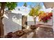 Private patio with wooden gate and landscaping at 2400 N 71St St # T, Scottsdale, AZ 85257