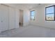 Bright bedroom with carpet, large windows, and ensuite bathroom at 25580 N 119Th St, Scottsdale, AZ 85255