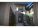 Modern front porch featuring a trellis wall, chairs, throw pillows and a gas fire pit at 25580 N 119Th St, Scottsdale, AZ 85255