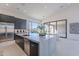 Open concept kitchen with island, stainless steel appliances, and access to patio at 25580 N 119Th St, Scottsdale, AZ 85255