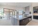 Modern kitchen with large island, stainless steel appliances, and fireplace at 25580 N 119Th St, Scottsdale, AZ 85255
