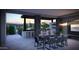 Outdoor kitchen and dining area with stone accents, TV, stainless steel appliances and mountain views at 25580 N 119Th St, Scottsdale, AZ 85255