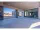 Covered patio with sliding glass doors and views of the desert landscape at 25580 N 119Th St, Scottsdale, AZ 85255