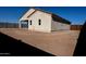 New construction home with a large, unlandscaped backyard and a wooden fence at 26293 W Desert Crest St, Casa Grande, AZ 85193